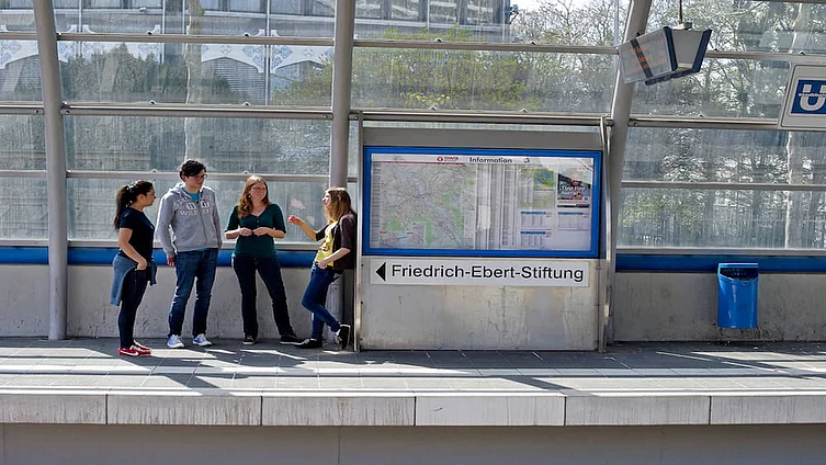 Young students standing at a underground rail station in Berlin.